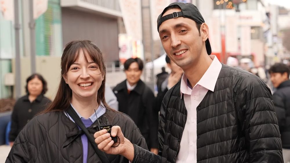 Sean interviewing a traveler on a busy street