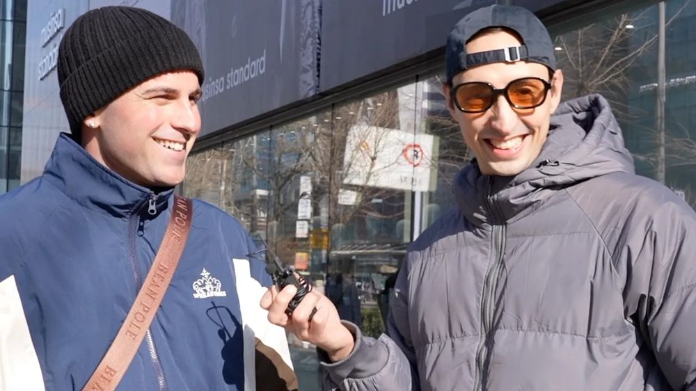 Sean interviewing a traveler outside a store in winter